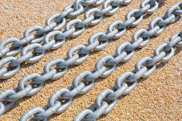 New galvanized metal chain placed on the ground