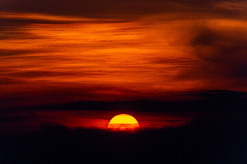 Deep orange sundown in sky at sunset.