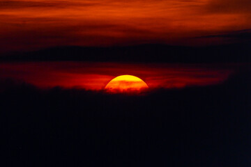 Deep orange sundown in sky at sunset.