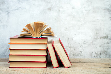 open book, books on the gray concrete background. Back to school. Education. Copy space for text.