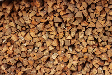 Split birch logs for the fireplace are stacked on top of each other. Wood for a picnic. Betulaceae. Firewood