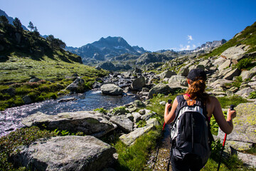 Young hiker girl summit to Ratera Peak in Aiguestortes and Sant Maurici National Park, Spain