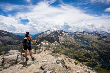 Fototapeta premium Young hiker girl summit to Montardo Peak in AIguestortes and Sant Maurici National Park, Spain