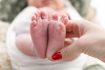 newborn baby's feet in the shape of her mom