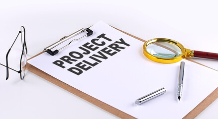 PROJECT DELIVERY text on clipboard on white background, business concept