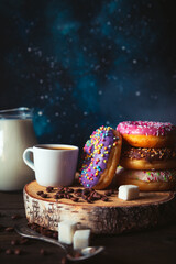 Stack of assorted donuts and a cup of coffee.