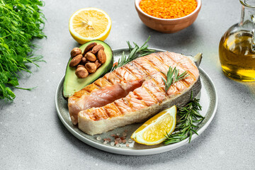 Salmon fish steak grilled, avocado and fresh vegetable salad. Ketogenic diet. Low carb high fat breakfast. Healthy food concept. place for text, top view