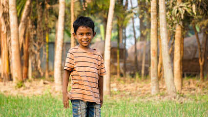 Fototapeta premium Bangladesh is the country of green. A child is playing in the green field. The child is enjoying mixing with nature.