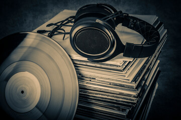Headphones on a stack of old vinyl records. Toned.