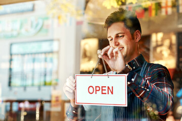 Coffee shop, open sign and a man small business owner standing a glass door for service or...