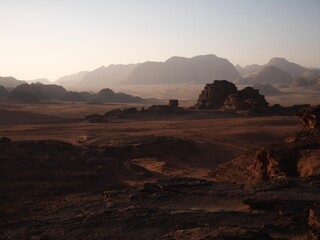 Fototapeta na wymiar Wadi Rum desert with rock formations and golden sands.