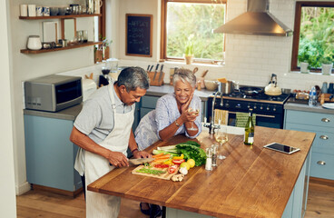 Cooking, happiness and old couple with wine at kitchen counter, healthy food and marriage bonding...