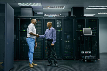 Handshake, partnership or men in server room of data center worker with a thank you hand shake for help. B2b deal agreement, shaking hands or people in collaboration for network glitch or IT support