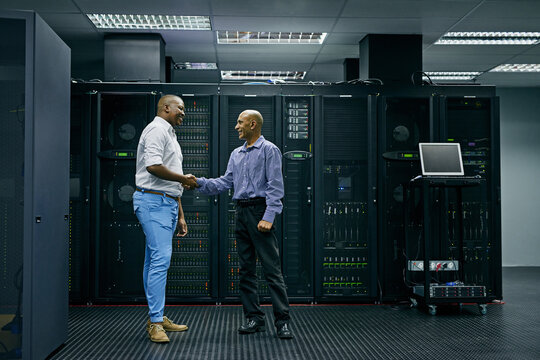 Handshake, partnership or men in server room of data center worker with a thank you hand shake for help. B2b deal agreement, shaking hands or people in collaboration for network glitch or IT support