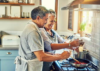 Help, cooking together and old couple in kitchen with smile, health and frying healthy food at stove. Love, senior man helping happy woman prepare lunch and meal in pan, retirement and dinner in home