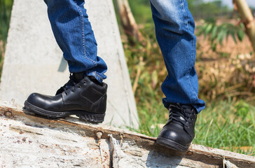 Wear safety shoes to ensure safety at work. construction workers wear safety shoes. People with factory safety concept