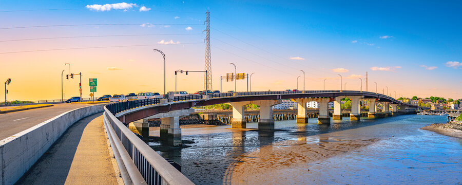 Essex Bridge over the Danvers River at low tide, next to Remond Park in Salem, Massachusetts, sunrise landscape during rush hour