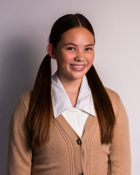 happy teen with pigtails and a cardigan