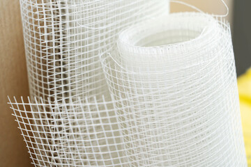 A roll of reinforcing mesh made of polymeric materials for plastering walls and ceilings or other...