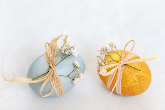 Colored Easter eggs on off-white background, festive decoration.
