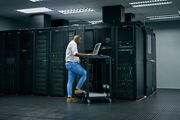 Server room, database and information technology with an engineer man at work on a network mainframe. Computer, programming and cybersecurity with a male technician working in IT support or safety - obrazy, fototapety, plakaty