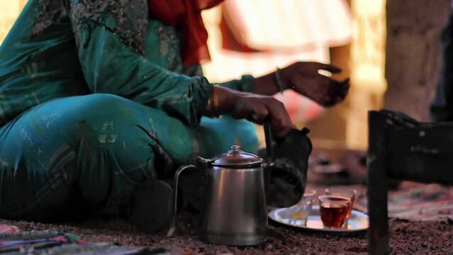 Bedouin woman cooking tea on the fire in Bedouin village, Egypt