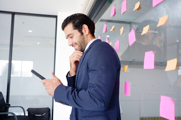 Fototapeta premium Young man in suit talking on business phone.