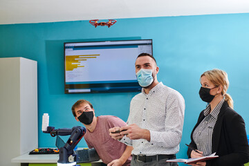  A group of students working together in a laboratory, dedicated to exploring the aerodynamic capabilities of a drone