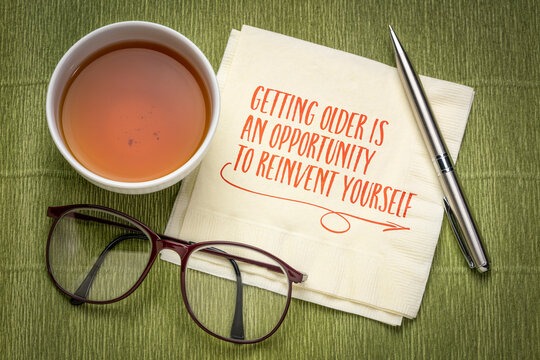 getting older is an opportunity to reinvent yourself - inspirational note on a napkin, healthy aging and personal development concept