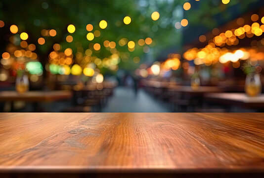 Empty wooden table and abstract blurred background of coffee shop or restaurant outdoor.
