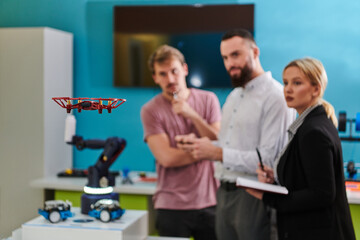  A group of students working together in a laboratory, dedicated to exploring the aerodynamic capabilities of a drone