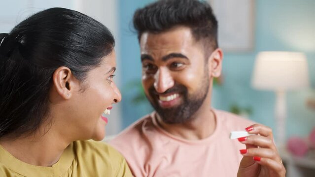 Indian couple got excited after seeing positive pregnancy test result at home - concept of expecting baby, good news and affection