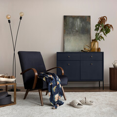 Creative composition of living room interior with mock up poster frame, velvet blue armchair,...