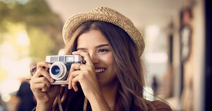 City, camera and photography of woman taking picture for summer, holiday and travel in urban street. Photographer, happy and female person with smile and hat taking retro photo for tourism outdoor