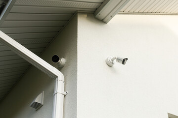 Security video cameras on white facade walls. Cctv security system. Modern cameras on farmhouse...