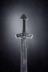  Medieval sword over dark misty background