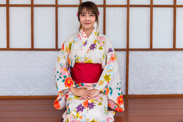 Young woman wearing Japanese traditional kimono in Japanese style wooden house
