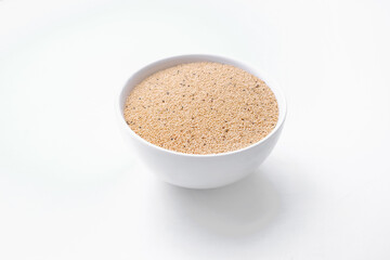Amaranth seed in bowl isolated on white. Copy space. top view
