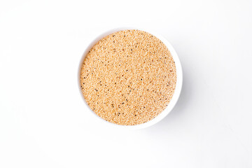 Amaranth seed in bowl isolated on white. Copy space. top view