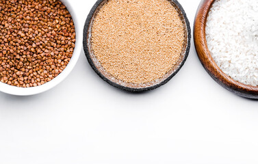 Rice, buckwheat, amaranth seeds. Gluten free seeds in bowls. Top view with copyspace.