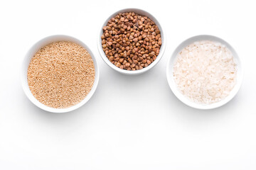 Rice, buckwheat, amaranth seeds. Gluten free seeds in bowls. Top view with copyspace.