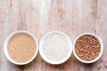Rice, buckwheat, amaranth seeds. Gluten free seeds in bowls. Top view with copyspace.