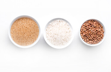 Rice, buckwheat, amaranth seeds. Gluten free seeds in bowls. Top view with copyspace.