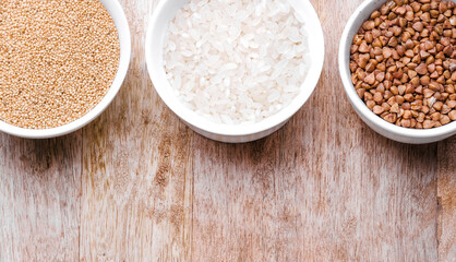 Rice, buckwheat, amaranth seeds. Gluten free seeds in bowls. Top view with copyspace.