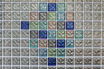 A wall of colorful glass blocks. Close up.