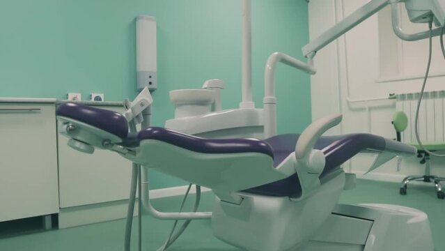 New dental chair in the dental office. Dental clinic interior design with chair and tools medical equipment. DS Dentist's office