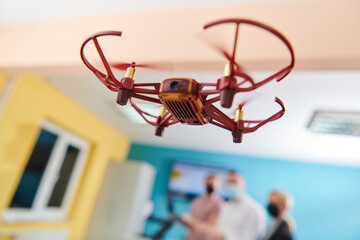  A group of students working together in a laboratory, dedicated to exploring the aerodynamic capabilities of a drone