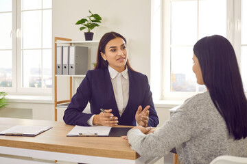 Two women meeting in the office. HR manager talking to a candidate at a job interview. Young...