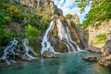 Fototapeta na wymiar impressive view of Cündüre waterfall, which is one of the biggest one around in Antalya and it springs out from many cracks and rifts on the face of the mountainous terrain, falling about 40 meters.