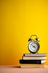 stack of books and clock on yellow background created with AI generative technology